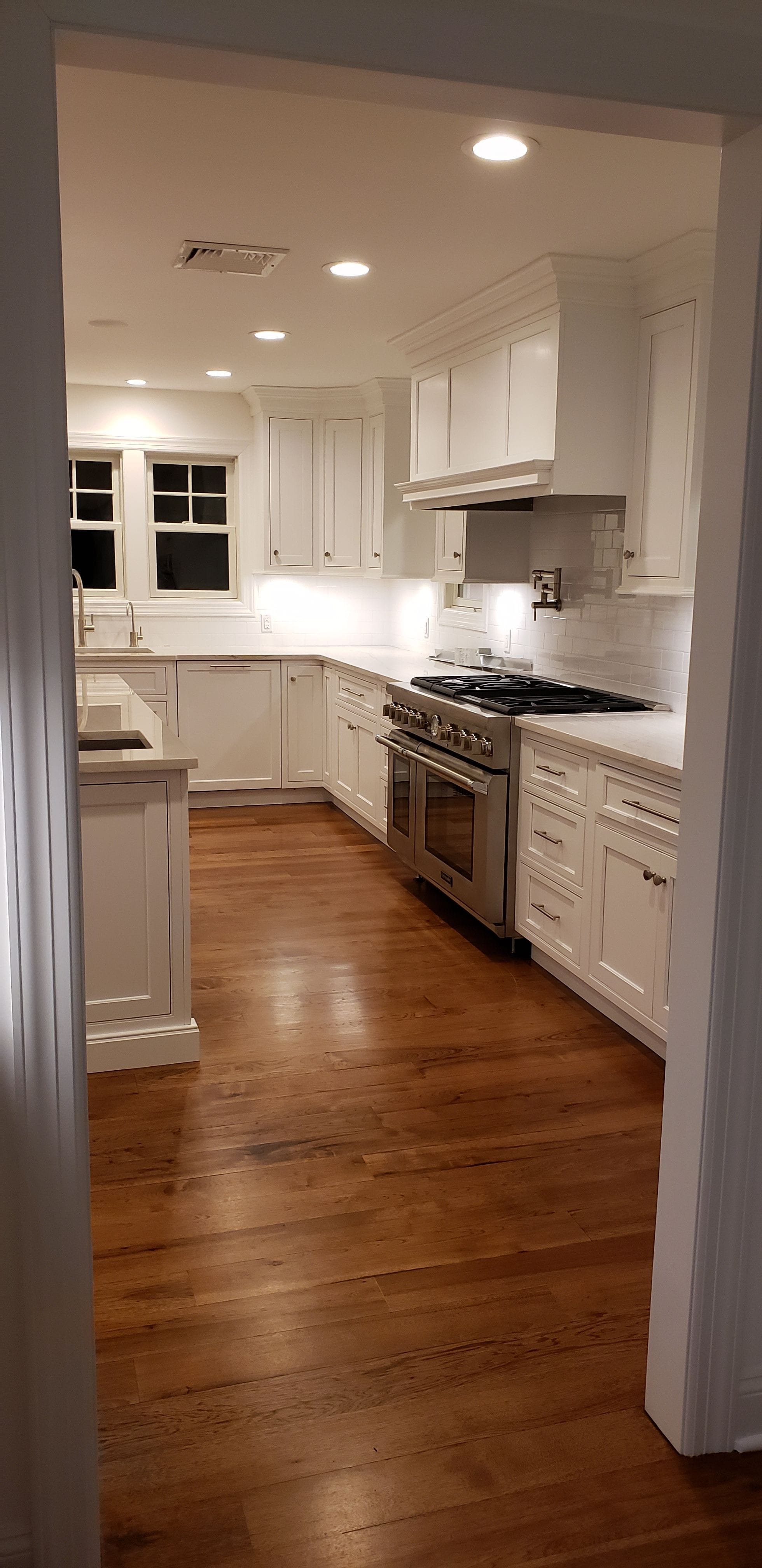 Clean white kitchen with accent lighting throughout