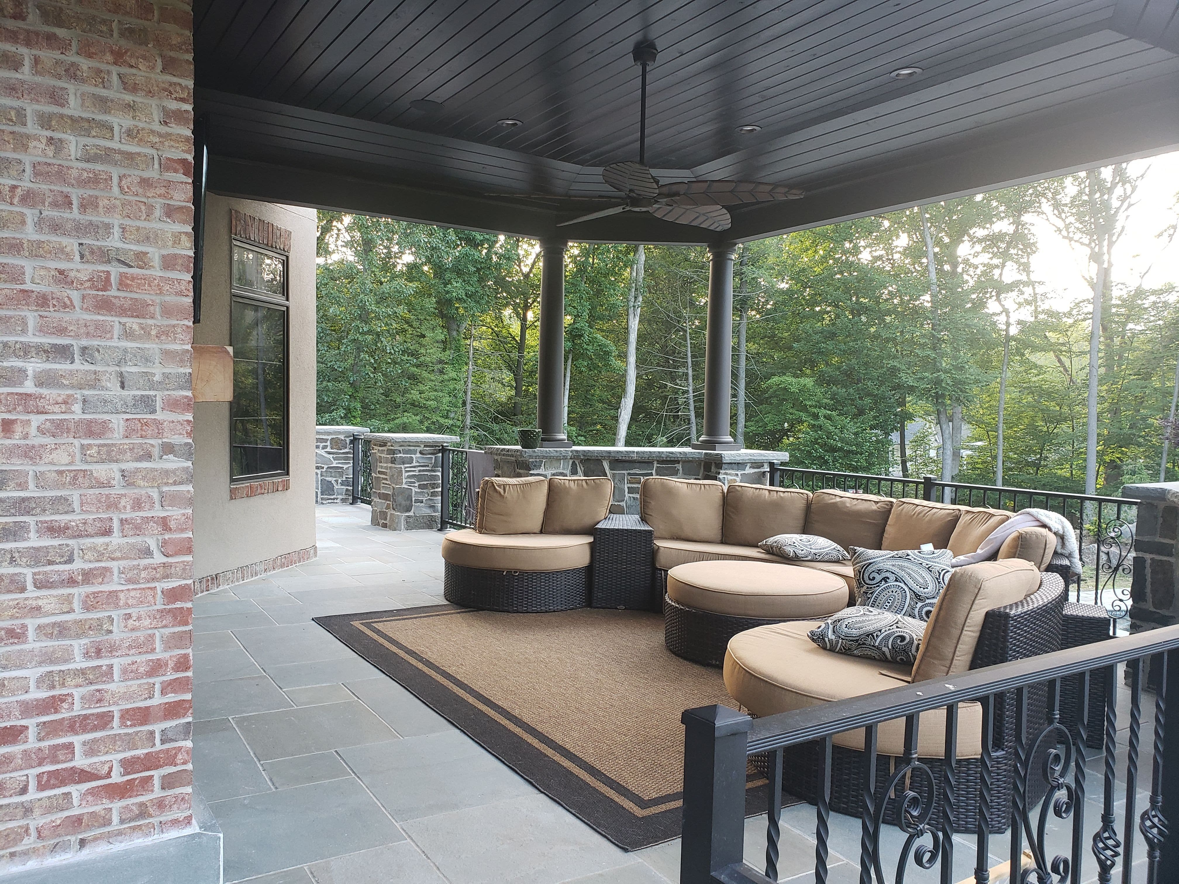 Set under recessed lighting and a ceiling fan this family can sit and look out over their beautiful backyard