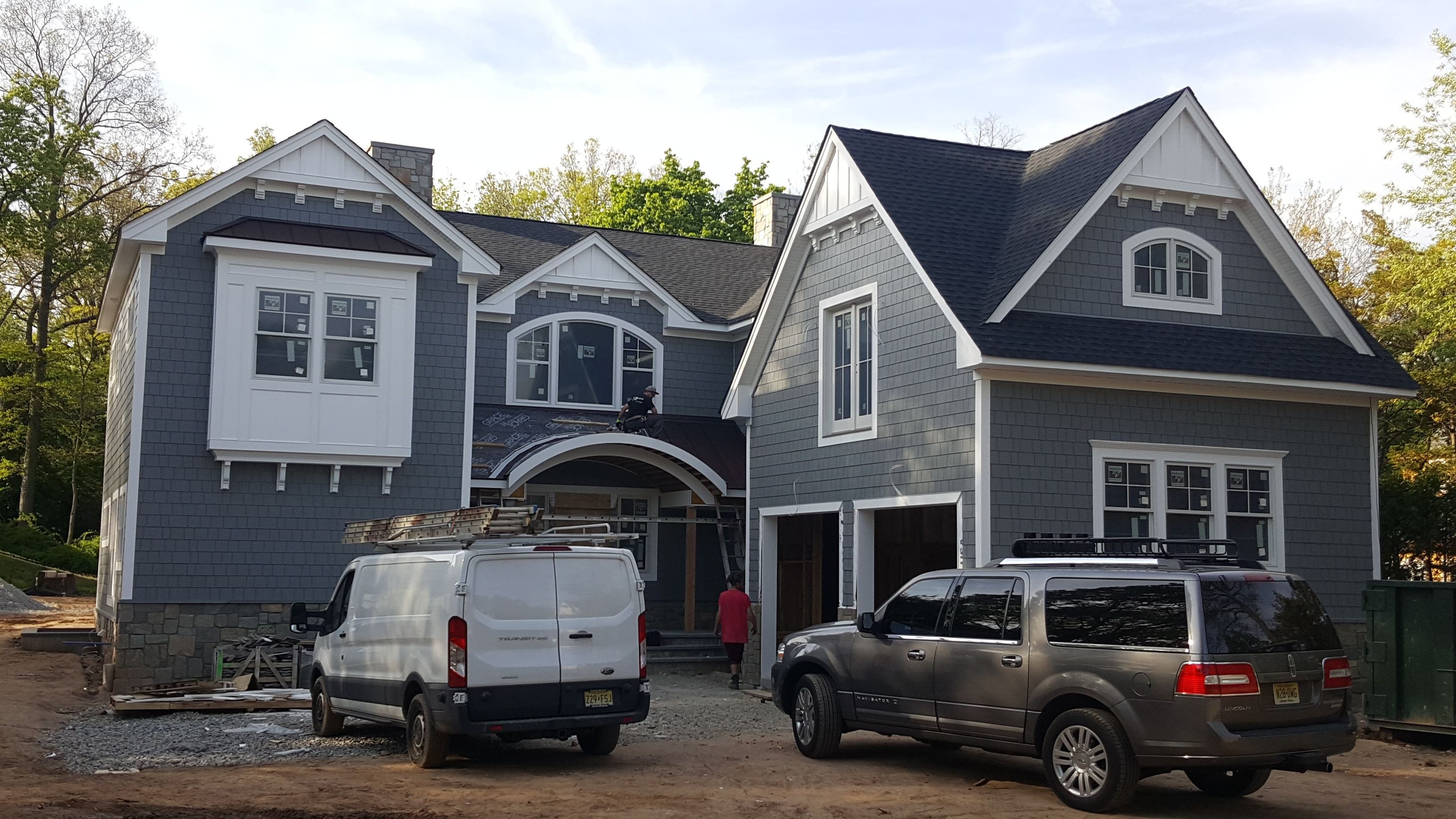 After long planning of the exterior the gray hardie-shake and white azek accents throughout made this home a traditional showpiece